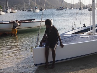 Young Akeem sitting protectively on Crystal Claire  watching Slip Away being launched