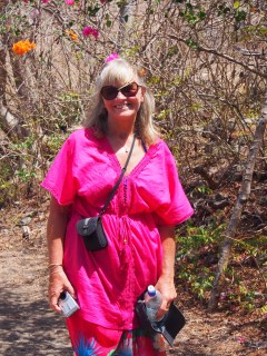 Pam demonstrating Union Island's bouganvillia matches her top