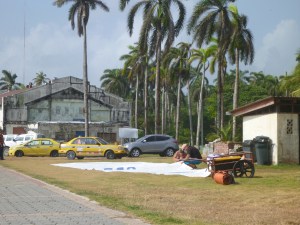 Temptress mainsail spread out on the grass, Shelter Bay